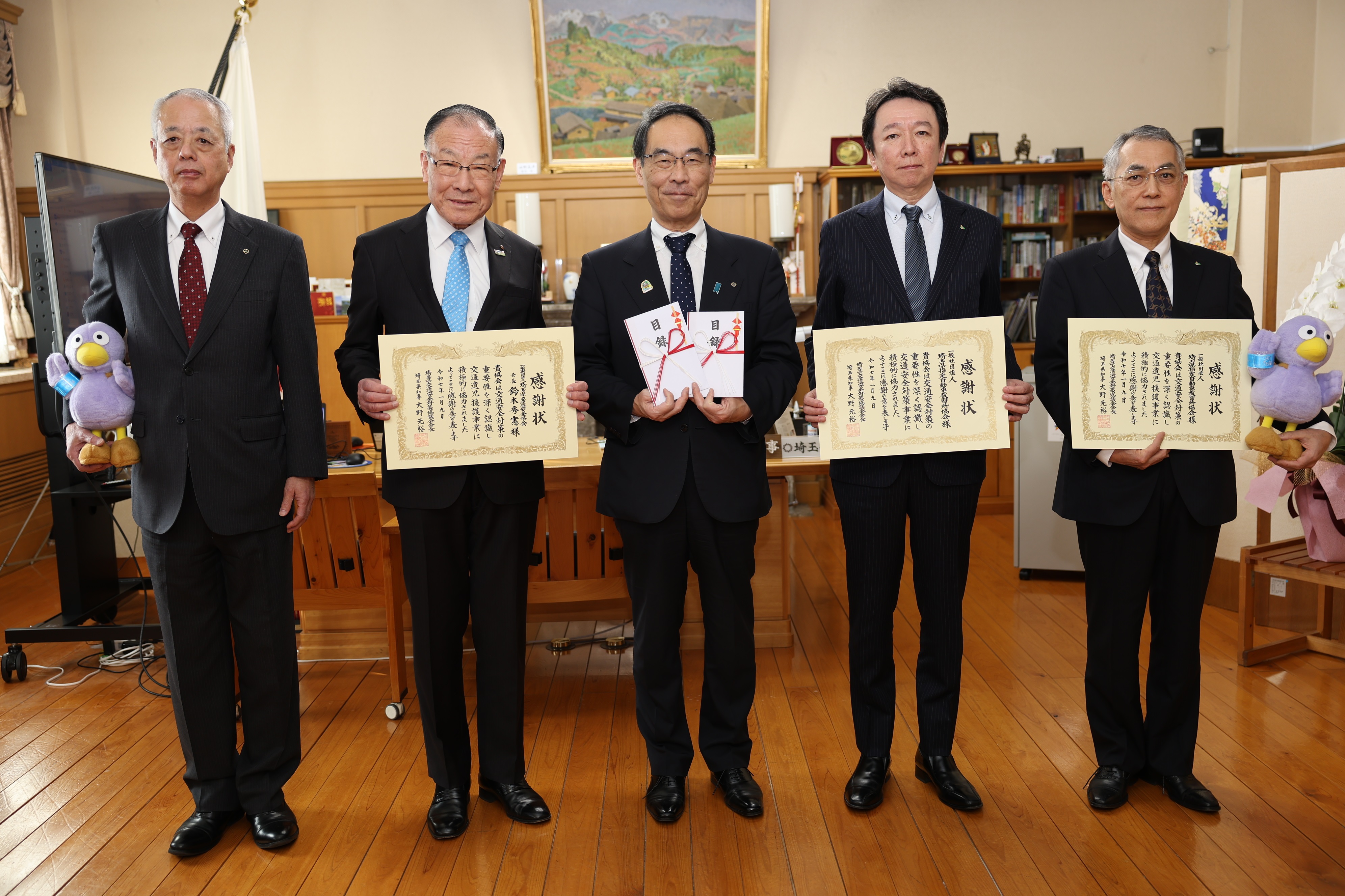 感謝状贈呈式で訪問者と集合写真を撮る知事の写真