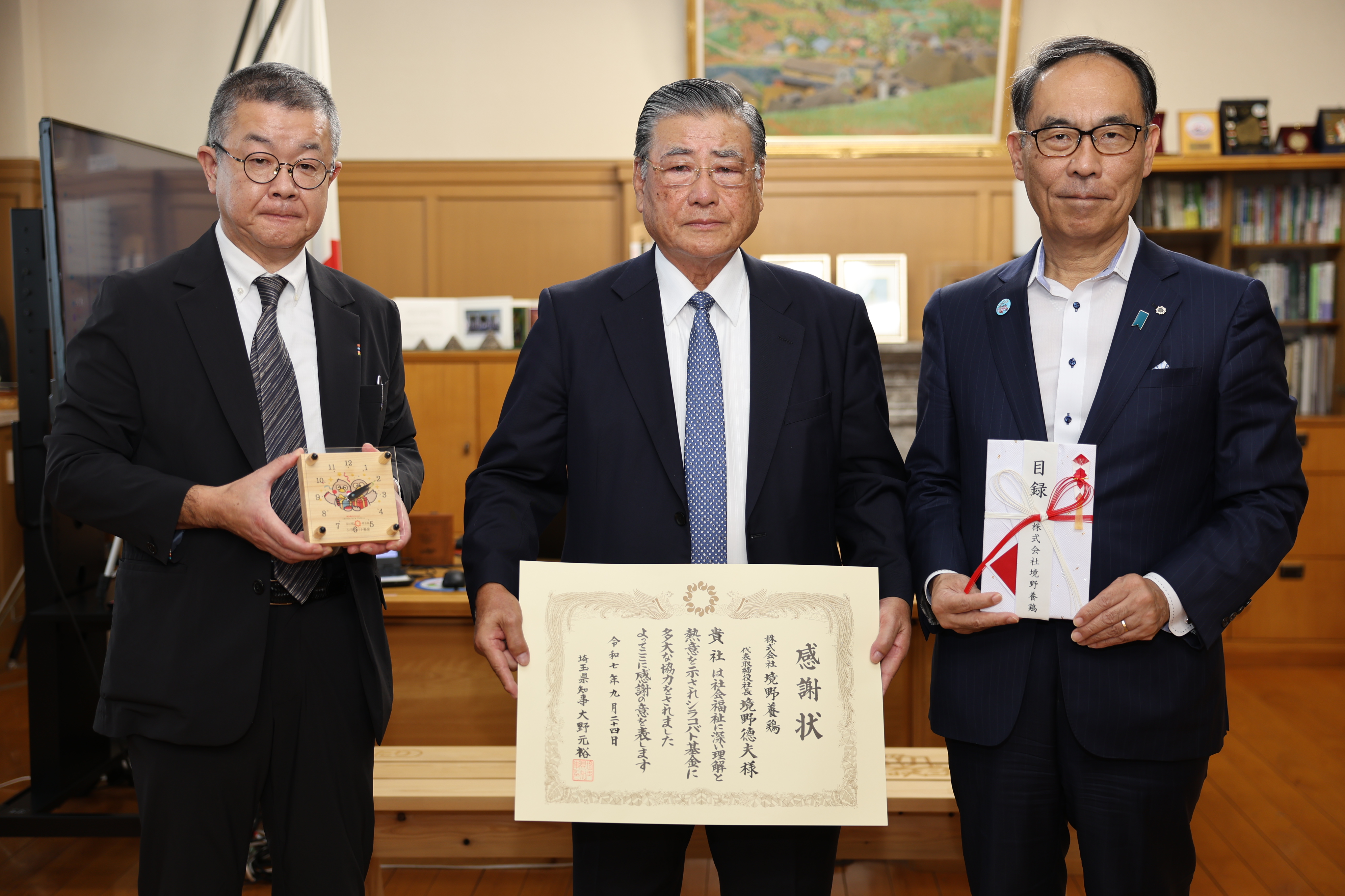 感謝状贈呈式で表彰者と記念写真を撮る知事の写真