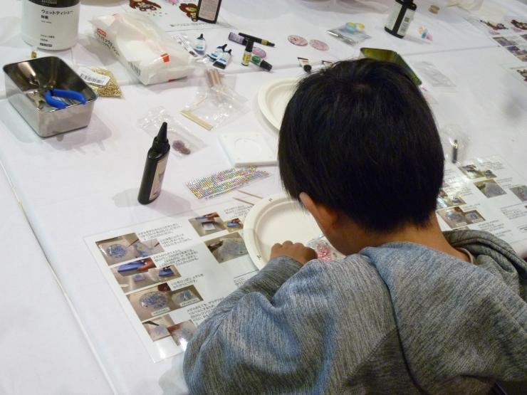 くませんくんのメダルを作るこども