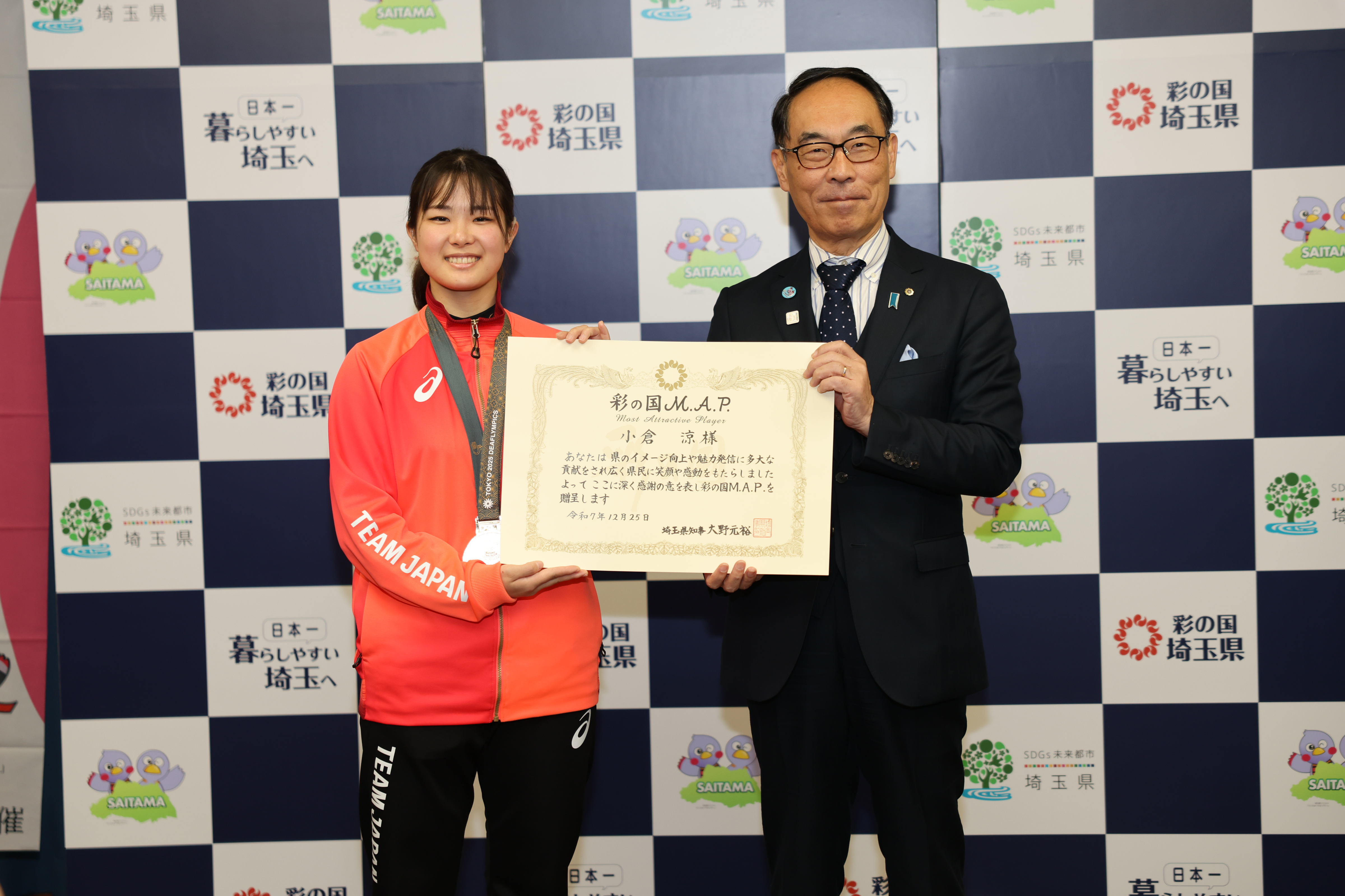 小倉選手ともに賞状をもちながら記念撮影をする知事の写真