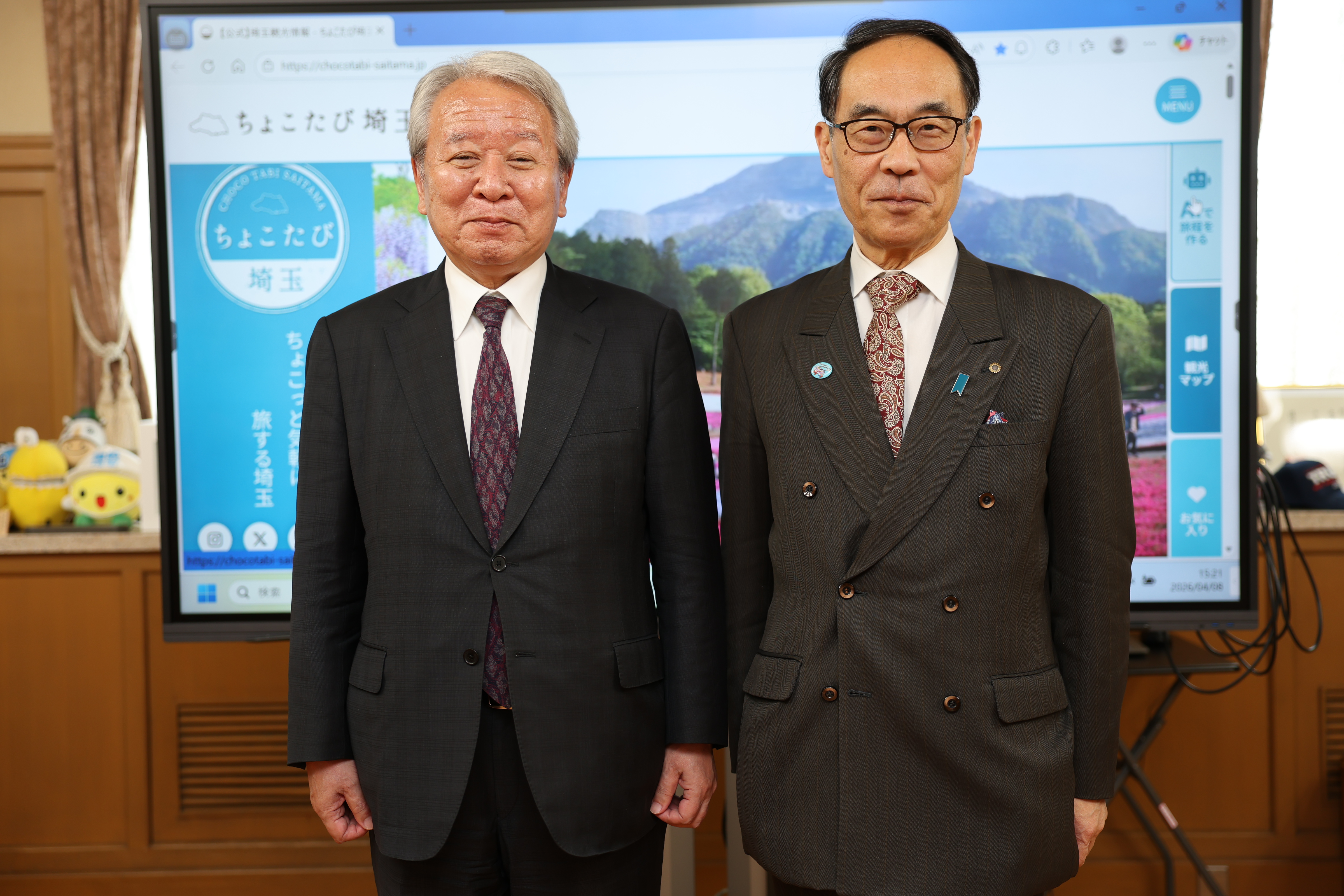 訪問者と記念写真を撮る知事の写真